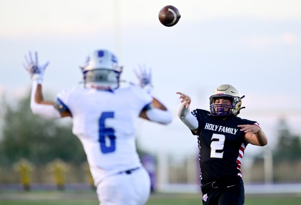 Broomfield's Brent Harris, left, tries to block the pass from Holy Family's Rylan Cooney, right, on Friday, Sept. 1, 2023. (Matthew Jonas/Staff Photographer)