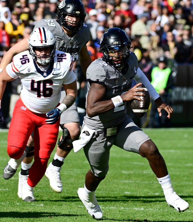 Colorado's Shedeur Sanders scrambles for a touchdown against Arizona in Pac-12 football on November 11, 2023.(Cliff Grassmick/Staff Photographer)