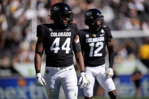 Colorado linebacker Jordan Domineck (44) and cornerback Travis Hunter (12) in the first half of an NCAA college football game Saturday, Sept. 9, 2023, in Boulder, Colo. (AP Photo/David Zalubowski)
