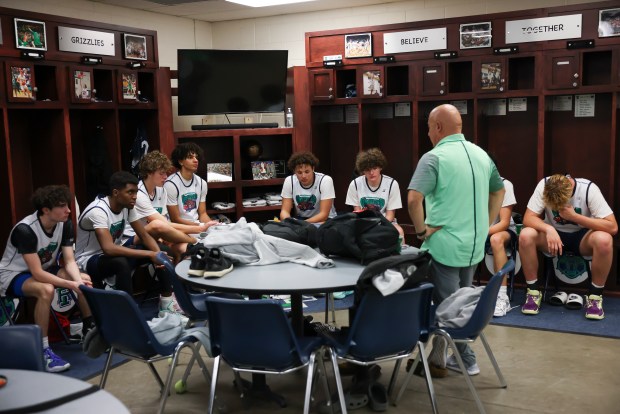 Andrew Crawford, fourth from left, and his teammates on the ThunderRidge basketball team get feedback from Coach Joe Ortiz in the locker room after a scrimmage on Nov. 23, 2022. (Photo by Kevin Mohatt/Special to The Denver Post)