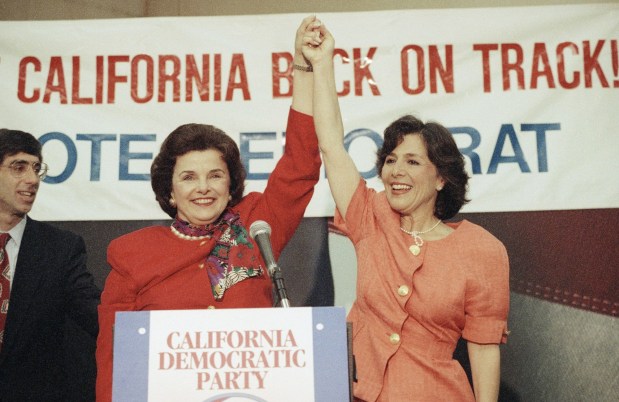 Former San Francisco Mayor Dianne Feinstein, left, and Rep. Barbara Boxer raise their hands in victory during an appearance at the airport in Burbank, California, Wednesday, June 3, 1992. The two women won the Democratic nominations for the two California U.S. Senate seats. (AP Photo/Paul Sakuma)