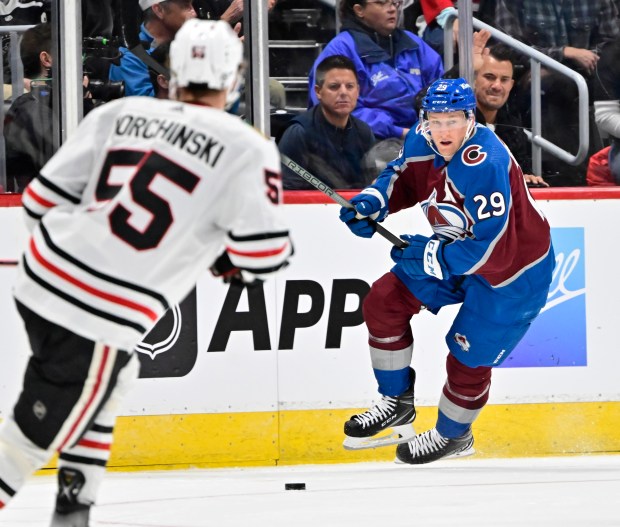 Colorado Avalanche center Nathan MacKinnon (29) chases down the puck Chicago Blackhawks defenseman Kevin Korchinski (55) in the first period at Ball Arena October 19, 2023. (Photo by Andy Cross/The Denver Post)