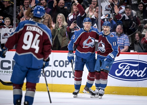 Andrew Cogliano (11) of the Colorado Avalanche celebrates his goal with Jack Johnson (3) as Joel Kiviranta (94) skates to join in the fun during the third period of the Avalanche's 8-2 win over the Anaheim Ducks at Ball Arena in Denver on Wednesday, November 15, 2023. (Photo by AAron Ontiveroz/The Denver Post)