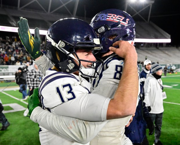 Columbine Rebels QB Reeve Holliday (13), left, celebrates with teammate Spencer Houle (80) after defeating the Cherry Creek Bruins to win the 5A Colorado State Championship at Canvas Stadium in Ft. Collins on Saturday, Dec. 02, 2023. (Photo by Andy Cross/The Denver Post)