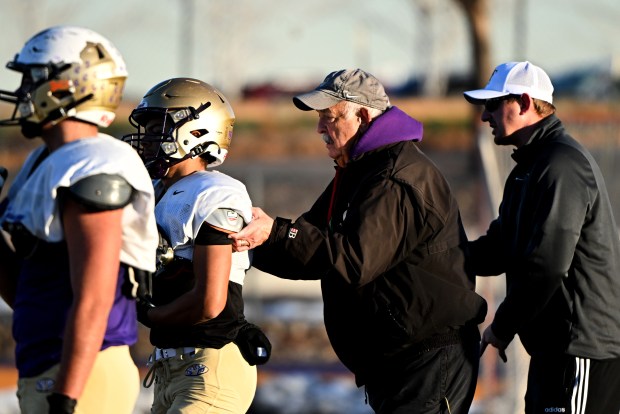 BROOMFIELD, CO - NOVEMBER 28: Offensive line coach Mike G. Gabriel, second from right, coaches his players during practice at Holy Family football field before practice on November 28, 2023 in Broomfield, Colorado. The football team has a long family history with deep roots going back generations and over a half century at the high school. Head coach Mike D, Gabriel, his father offensive line coach Mike G. Gabriel, Sr and brother Assistant coach Mark Gabriel are all part of the coaching staff. Their kids play on the team as well. Star running back and safety Dominic Gabriel, his brother and sophomore player Nick and cousin Andrew Berens, also a sophomore all play for the team. Holy Family will be taking on Lutheran at the 3A state football championships this weekend. (Photo by Helen H. Richardson/The Denver Post)