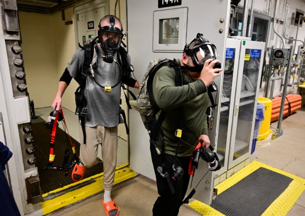 Maintenance workers, Ryan Watson, left, and Andrew Stout, right, exit the airlock after a two-hour shift inside the Pueblo Chemical Agent-Destruction Pilot Plant (PCAPP) at the U.S. Army Pueblo Chemical Depot Oct. 18, 2023. (Photo by Andy Cross/The Denver Post)