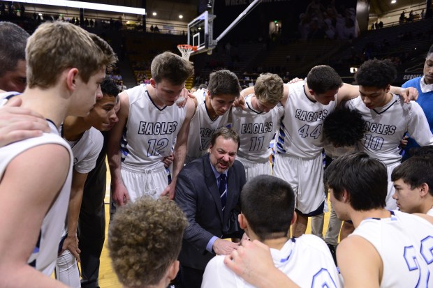 The Valor Christian Eagles huddle around head coach Troy Pachner before the start of a game against Pueblo West Cyclones at the Coors Events Center in Boulder on March 12, 2016. (Photo by Brent Lewis/The Denver Post)