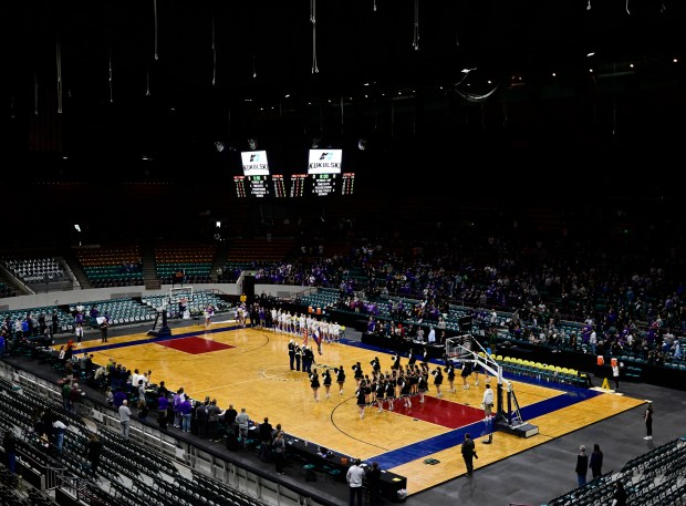 Holy Family Tigers girls, left, and the D'Evelynn Jaguars line up for the National Anthem to start the championship day for the Colorado state high school basketball championships at the Denver Coliseum March 11, 2023. (Photo by Andy Cross/The Denver Post)