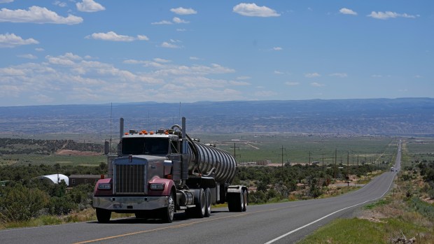 A tanker truck transports crude oil on a highway near Duchesne, Utah on Thursday, July 13, 2023. Uinta Basin Railway, one of the United States' biggest rail investment in more than a century, could be an 88-mile line in Utah that would run through tribal lands and national forest to move oil and gas to the national rail network. Critics question investing billions in oil and gas infrastructure as the country seeks to use less of the fossil fuels that worsen climate change. (AP Photo/Rick Bowmer)