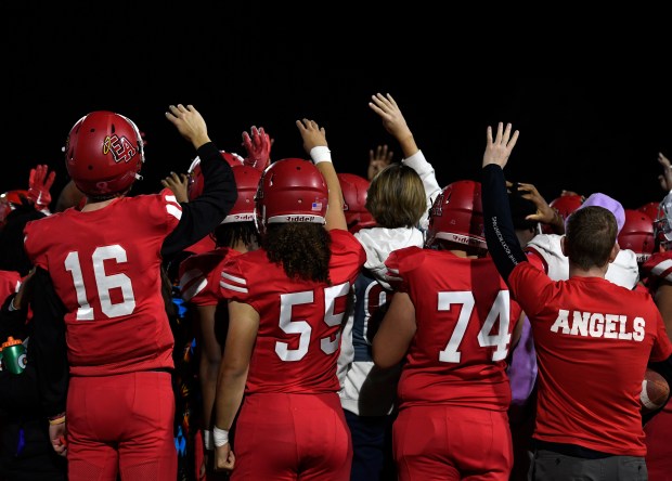 DENVER, CO - NOVEMBER 3: Denver East's players hold up four fingers signaling that the 4th quarter will be theirs as Mullen High School plays Denver East High School in the first round of 5A football playoffs at All-City Stadium on November 3, 2023 in Denver, Colorado. (Photo By Kathryn Scott/Special to The Denver Post)